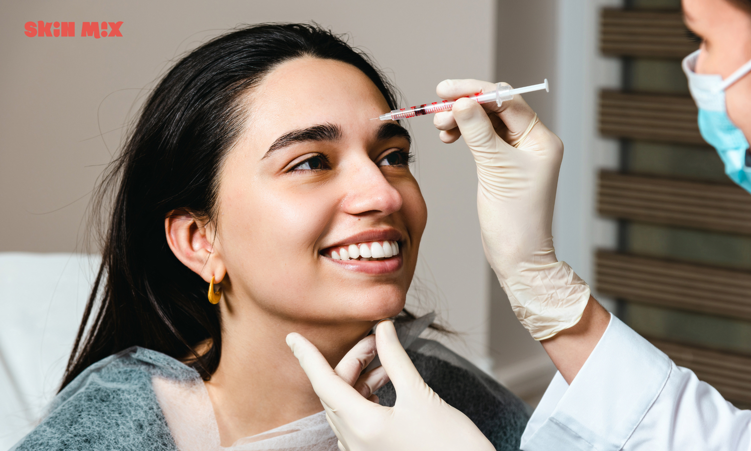 Woman smiling while receiving botox treatment in Denver